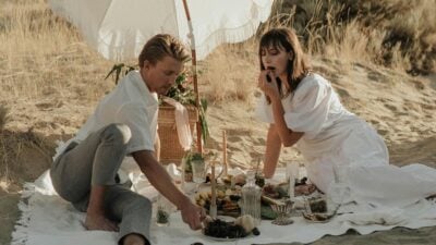 The-Adult-Man-12-Second-Date-Ideas-That-Dont-Suck-from-a-Dating-Coach-Couple-Eating-on-Picnic-on-Sandy-Beach