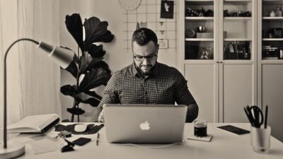 man sitting at his desk working masculine office