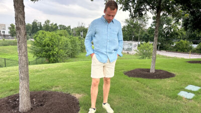 Model-wearing-Madda-Fella-Ernest-Linen-Shirt-and-Corduroy-Drawstring-Shorts-on-Grass