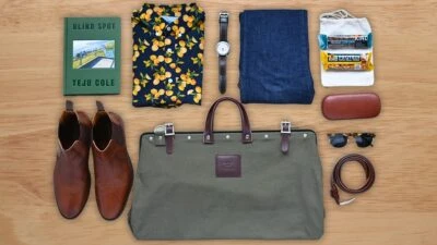 The Adult Man 57 Things Every Man Should Own Assorted Mens Products Laid Out Over Wood Flooring