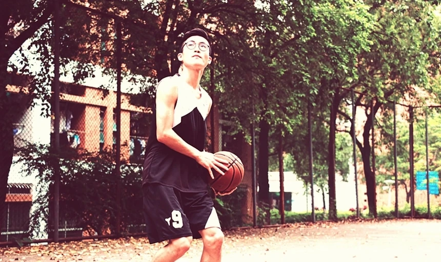 30 Things Every Man Should Do Before Turning Thirty 41 Man playing basketball with glasses in black and white uniform