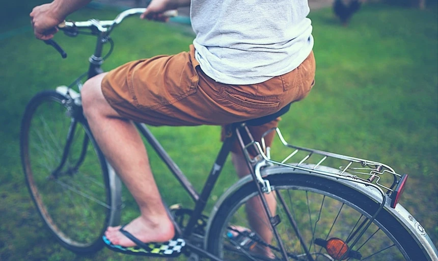 38 Lessons: The Ultimate Guide to Men's Fashion From a Female Perspective 136 Man riding bike with brown shorts