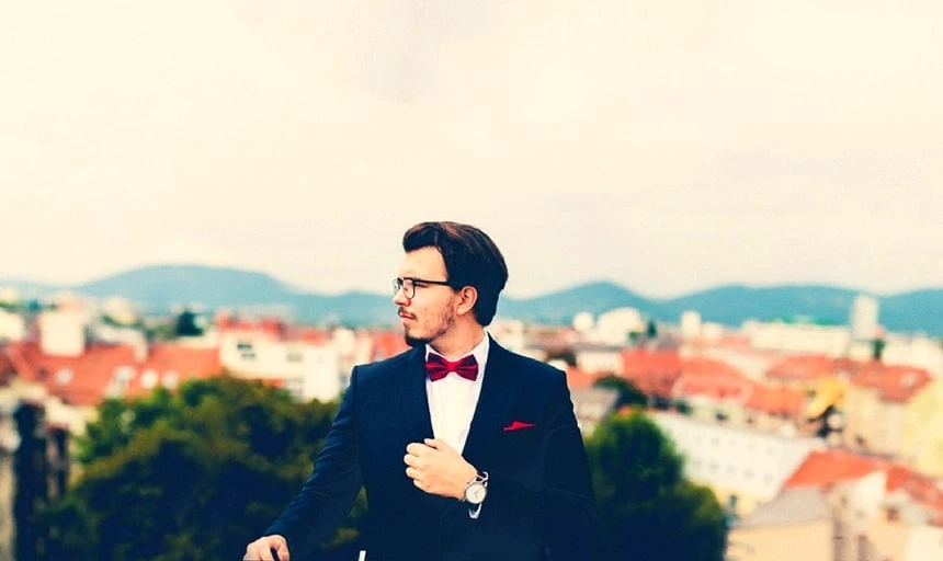 38 Lessons: The Ultimate Guide to Men's Fashion From a Female Perspective 140 Man with red bow tie and suit outside with great view
