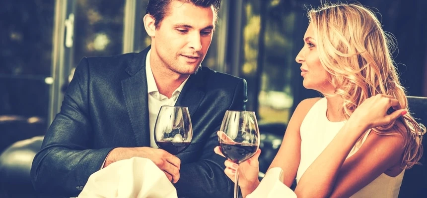 Attractive couple on a date in a restaurant with red wine Attractive couple on a date in a restaurant with red wine