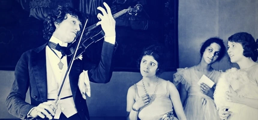 Man playing violin with women groupies Man playing violin with women groupies