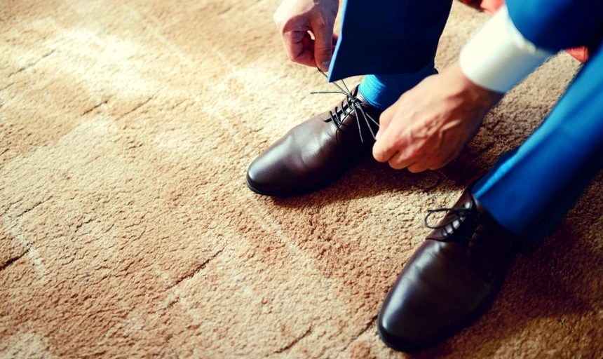 Man in blue suit with brown shoes tieing shoelaces 2 1 1 1 1 1 1 1 1 1
