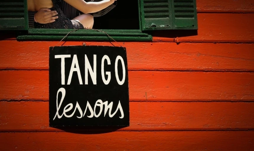 Sexy man and woman getting tango lessons