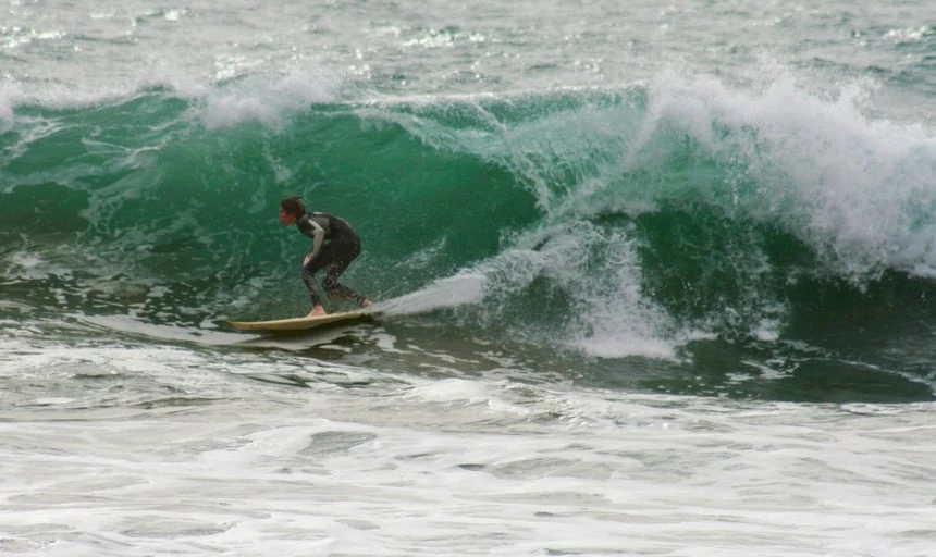 Surfer surfing in Lagos, Portugal