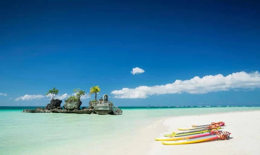 Tropical beach and Christian shrine on Boracay Island, Phillipines with boats