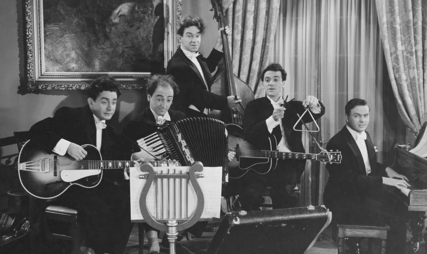A band featuring guitar, accordian, drums, bass, triangle - vintage style in black and white