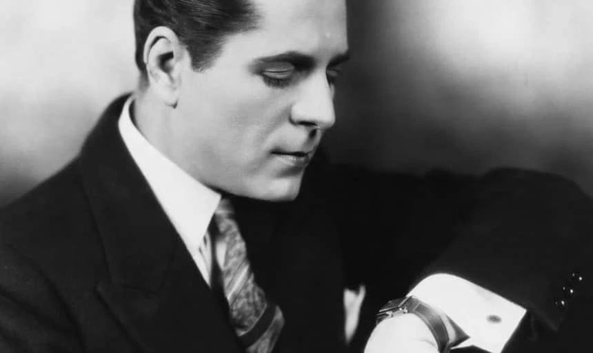 Business man looking at watch in suit - black and white vintage
