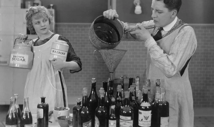 Man and woman distilling spirits and making alcohol - black and white vintage