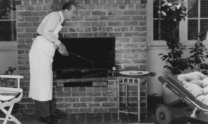 Man barbecueing outside - black and white vintage style