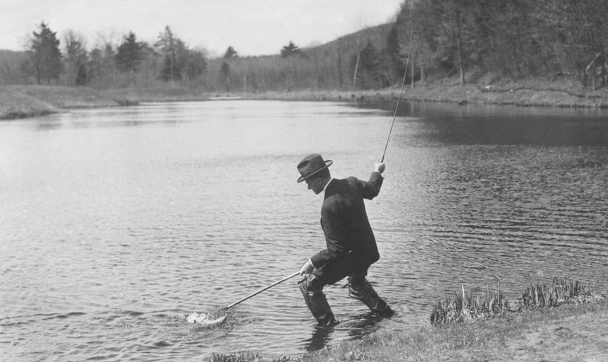 Man fishing with a net and rod - black and white vintage