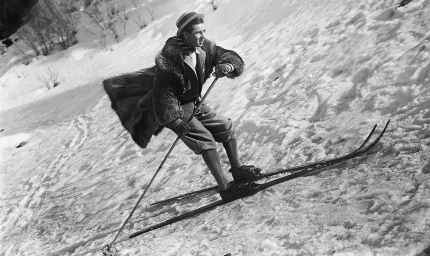 Man skiing with hat and coat on - black and white vintage style image