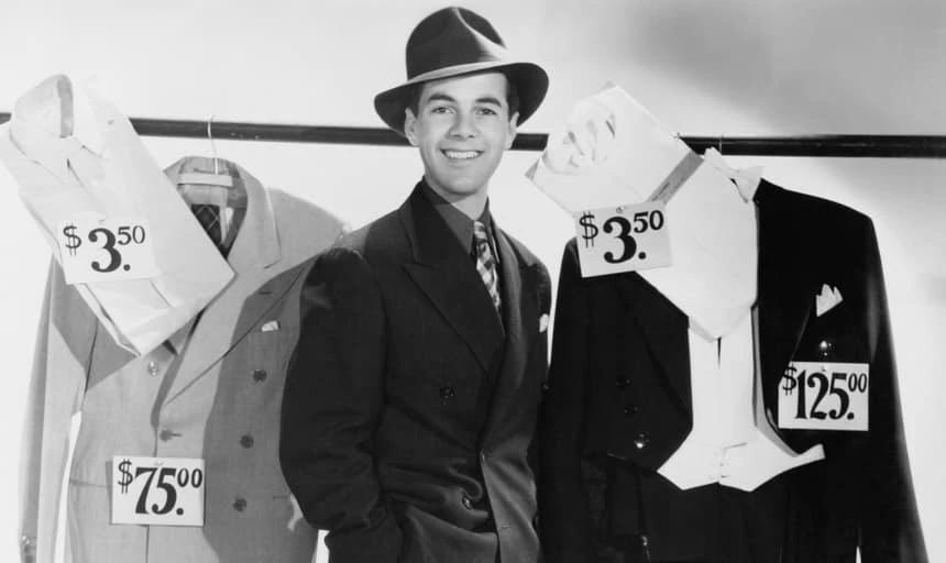 Sartorial business man surrounded by retail fashion items - black and white vintage