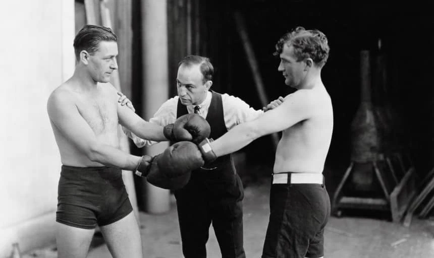Two men boxing with referee about to start the fight - vintage black and white