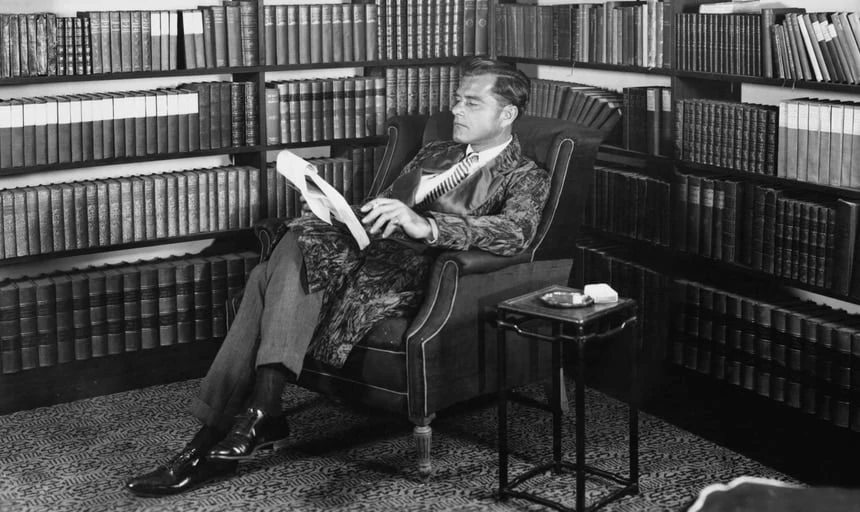 Vintage image of a man reading in his library study - black and white
