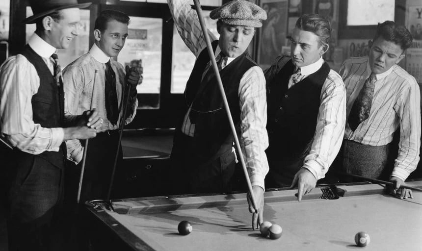Vintage men playing pool, playing a tough shot