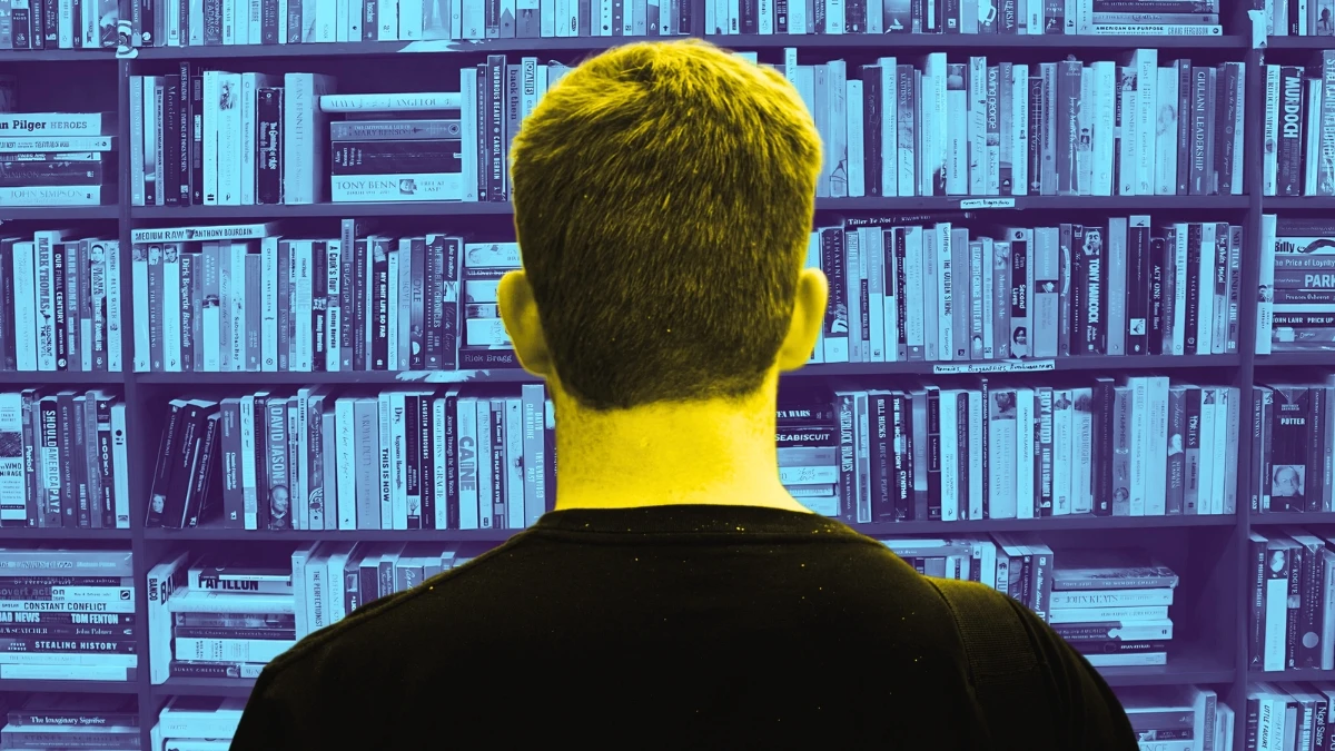 The Adult Man 10 Self Help Books That Will Transform a Man's Life Man Browsing Bookshelf