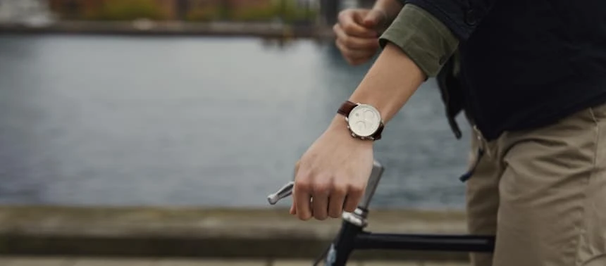 Model Wearing Nordgreen Pioneer While Riding a Bike Side On