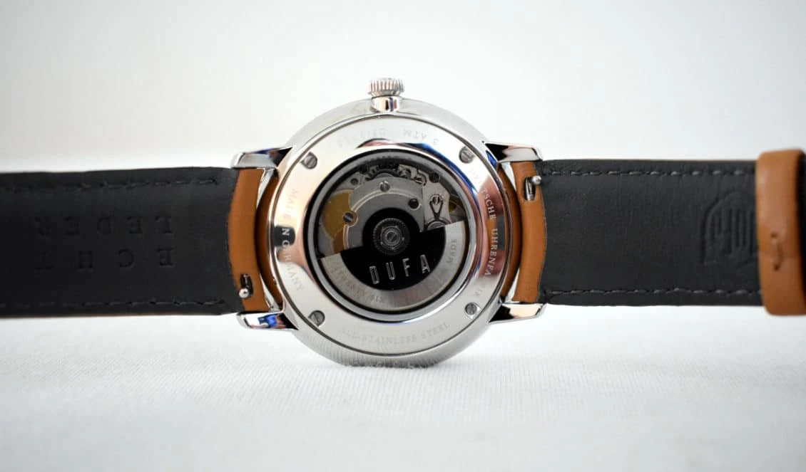 Dufa Bayer Case Back Sitting on White Background With Strap