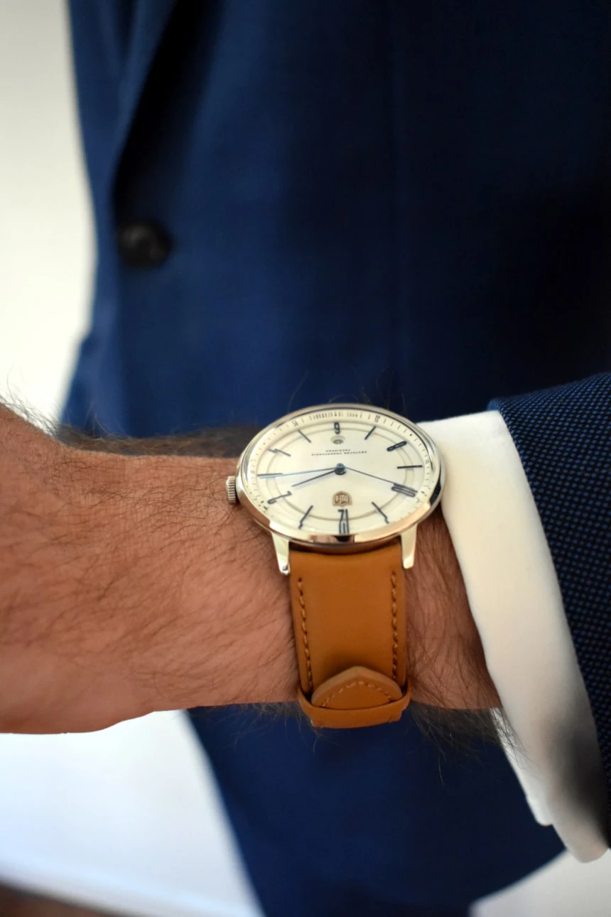 Model Wearing Dufa Bayer In Suit Holding Arm Out