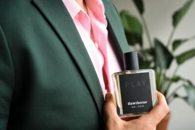 2019/09/Cologne-for-Men-Male-Model-Wearing-Charcoal-Suit-With-Pink-Shirt-And-Holding-Hawthorne-Play-Fragrance-Side-Angle.jpgw3.webp