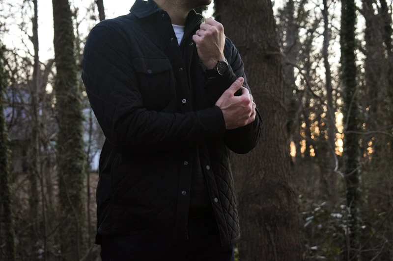 model with watch and quilted jacket closeup