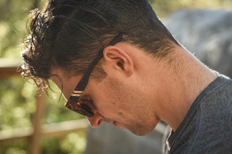 model looking down wearing blenders charging lion sunglasses