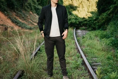 2020/07/Best-Bomber-Jackets-for-Men_-Male-model-wearing-Paige-Bomber-Jacket-and-Cargo-pants-on-railroad-track-outside.jpgw3.webp