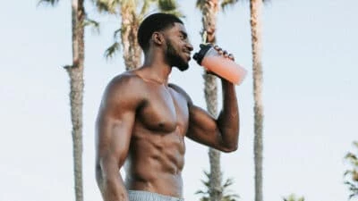 2021/03/Best-Protein-Shake-Recipes-for-Muscle-Gain_-Muscular-Black-Man-Smiling-and-Drinking-Protein-Shake-Outside-.jpgw3.webp