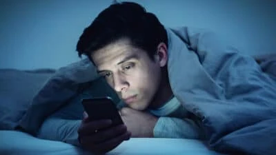 2021/03/Oneitis_-Man-in-Bed-with-Phone-Sad-Waiting-for-a-Text-Message-From-His-Crush.jpgw3.webp