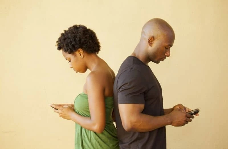 Black couple ignoring each other while