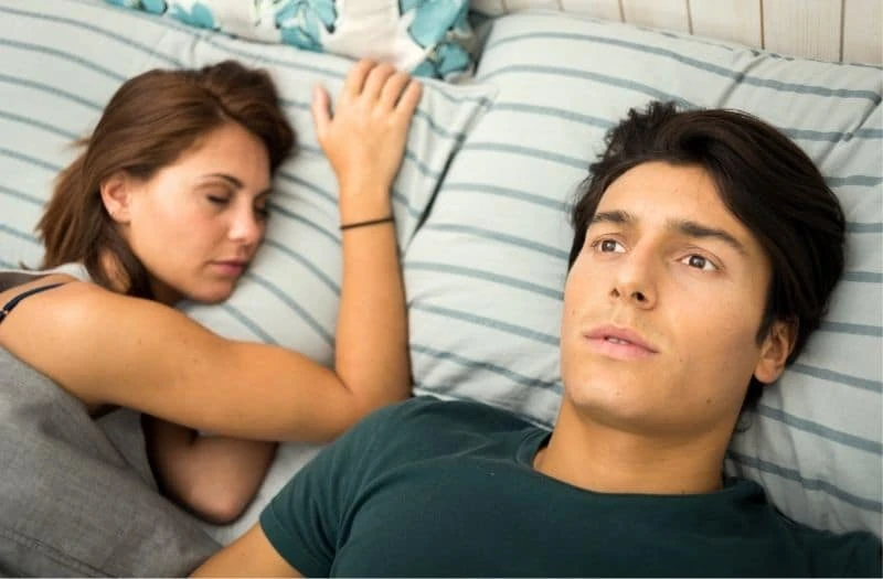 Couple in bed with man awake worried