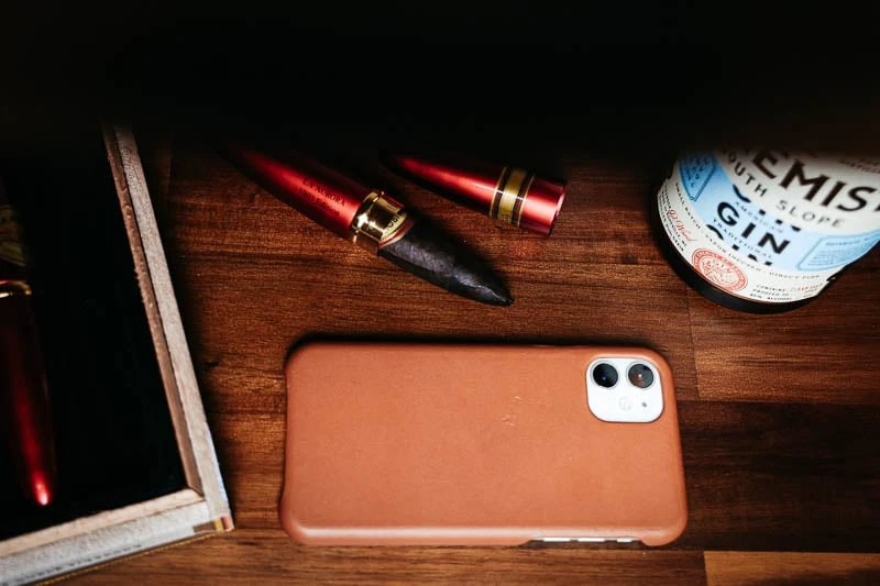 Anson Calder Review: I Tried Their Most Popular Accessories 42 Anson Calder iphone case against wooden shelf