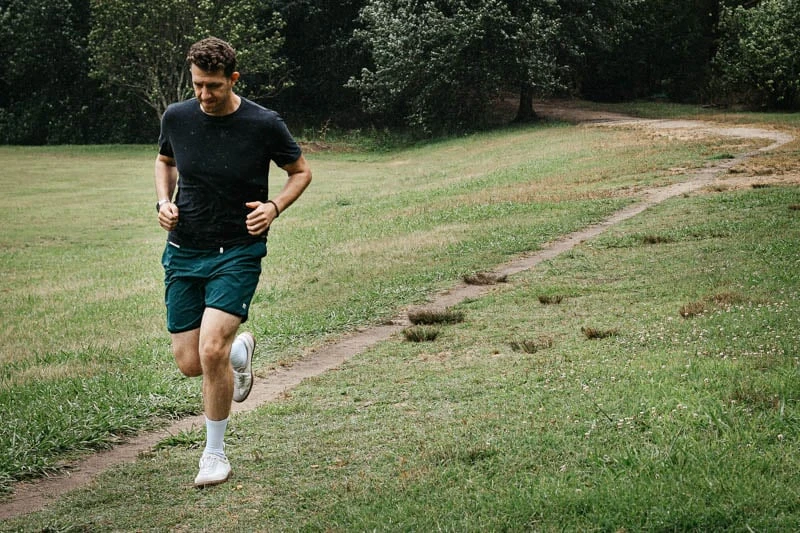 Vuori Clothing Review: We Tried Their Most Popular Styles 95 model running wearing vuori workout shorts and tradewind t shirt