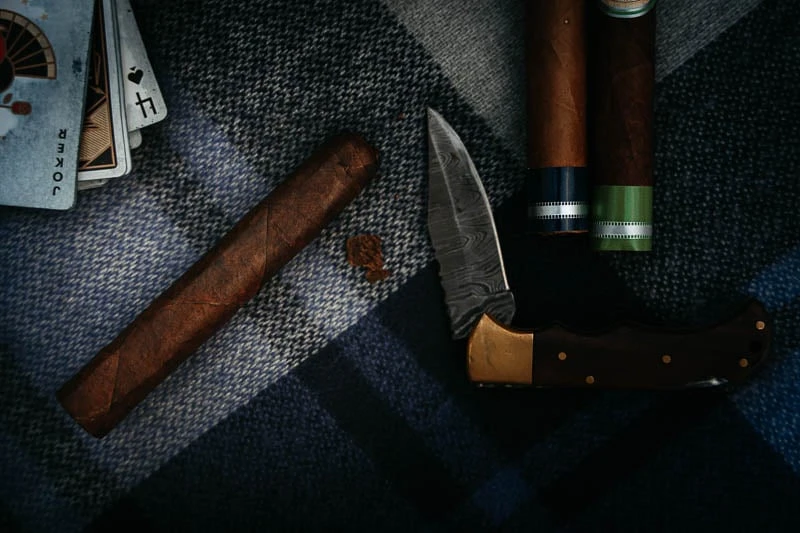 Cigars 101: What Every Guy Must Know Before Lighting Up 35 La Aurora cigar cut with knife