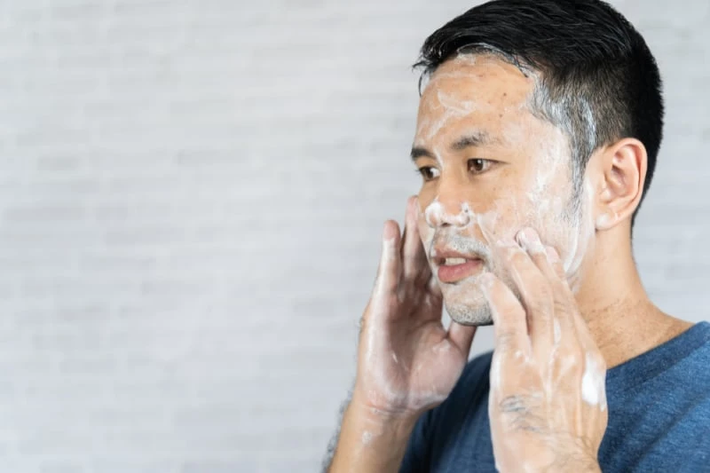 How to Care for Oily Skin: A Man’s Guide for 2024 45 man using face wash on skin