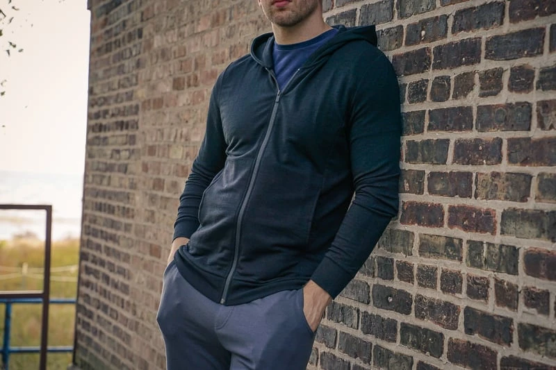 Unbound Merino Turns Luxe Wool into Utilitarian Might 54 man wearing black Unbound Merino hoodie and sweatpants
