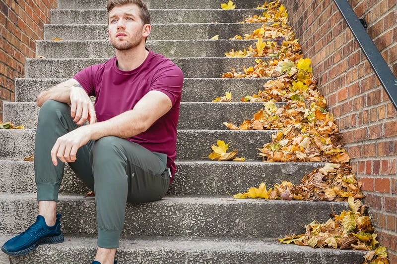 Alo Yoga Review: How Does This Activewear Brand Stand Out from the Rest? 47 Man in Alo Yoga clothes sitting on steps
