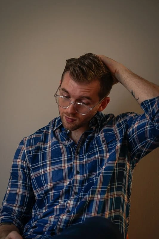 johnnie-O Clothing Review: Does Preppy Style Translate to West Coast Casual? 34 Man wearing Johnnie O shirt on chair