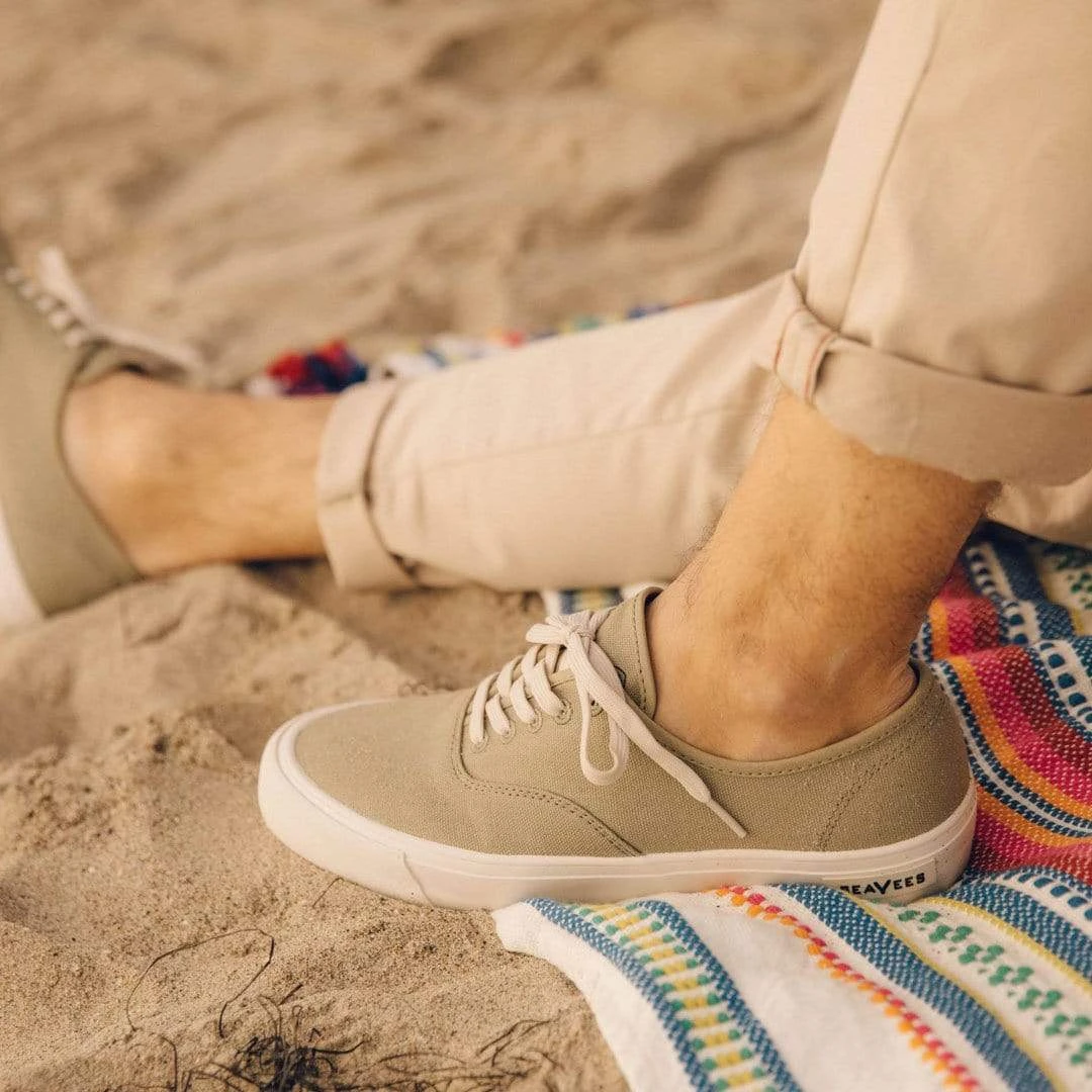 Model sitting in SeaVees Legend Sneaker