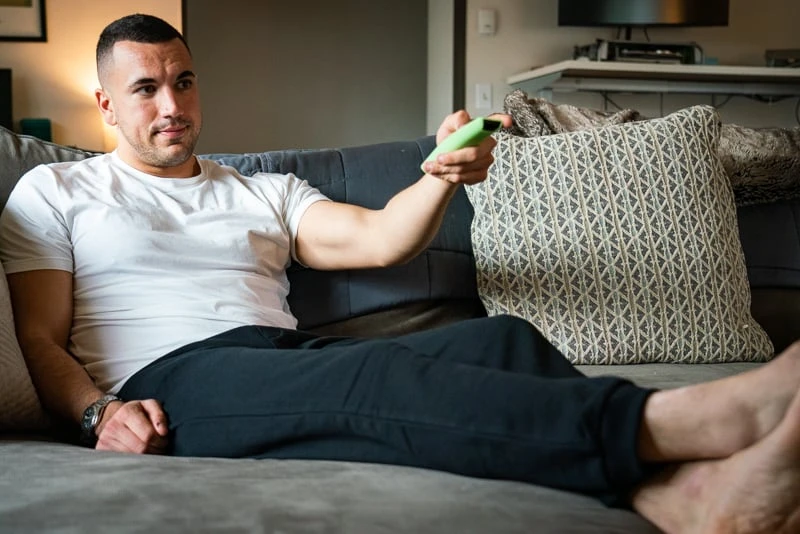 Man relaxes and unwinds at home