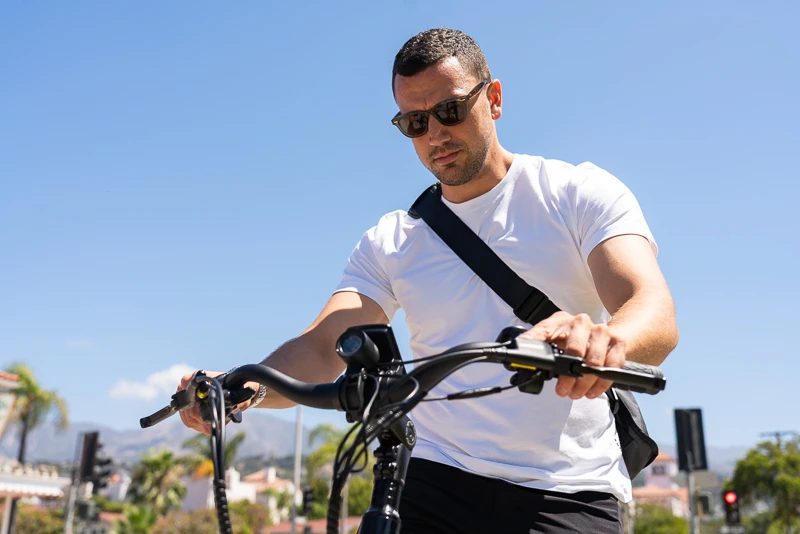 Model holding handlebars of Aventon ebike