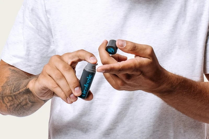 Tattooed man dispensing Geologie Anti Aging Eye Cream