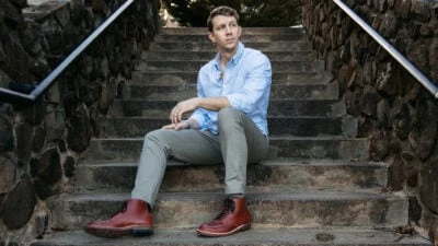 Charles Tyrwhitt Review Model Wearing Washed Oxford Button Up and Lightweight Pants Outside on Stairs