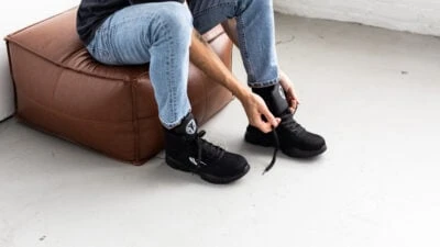 Indestructible Shoes Review Model Lacing up J3 with blue jeans