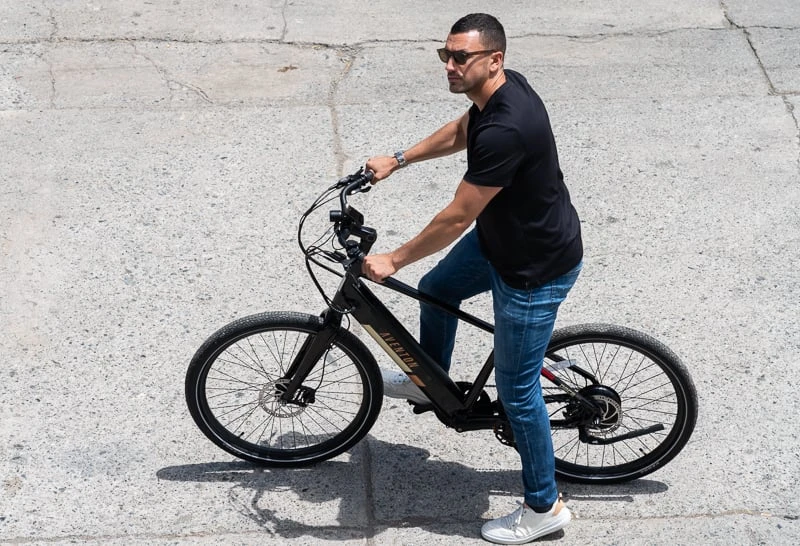 7 Most Comfortable eBikes: Snag a Cushy Ride 47 Model riding Aventon ebike downtown