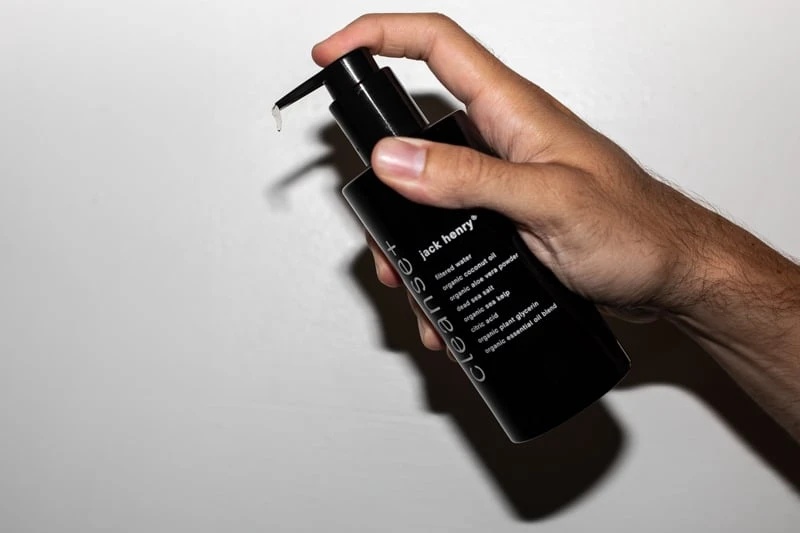 Jack Henry Cleanse squeezing out cleanser on white background